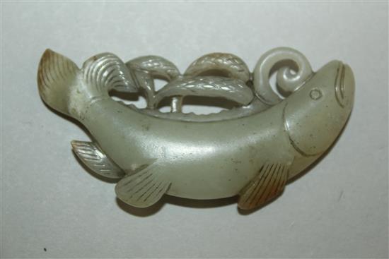 A Chinese pale celadon and russet jade carving of a fish, 19th century, 6.5cm